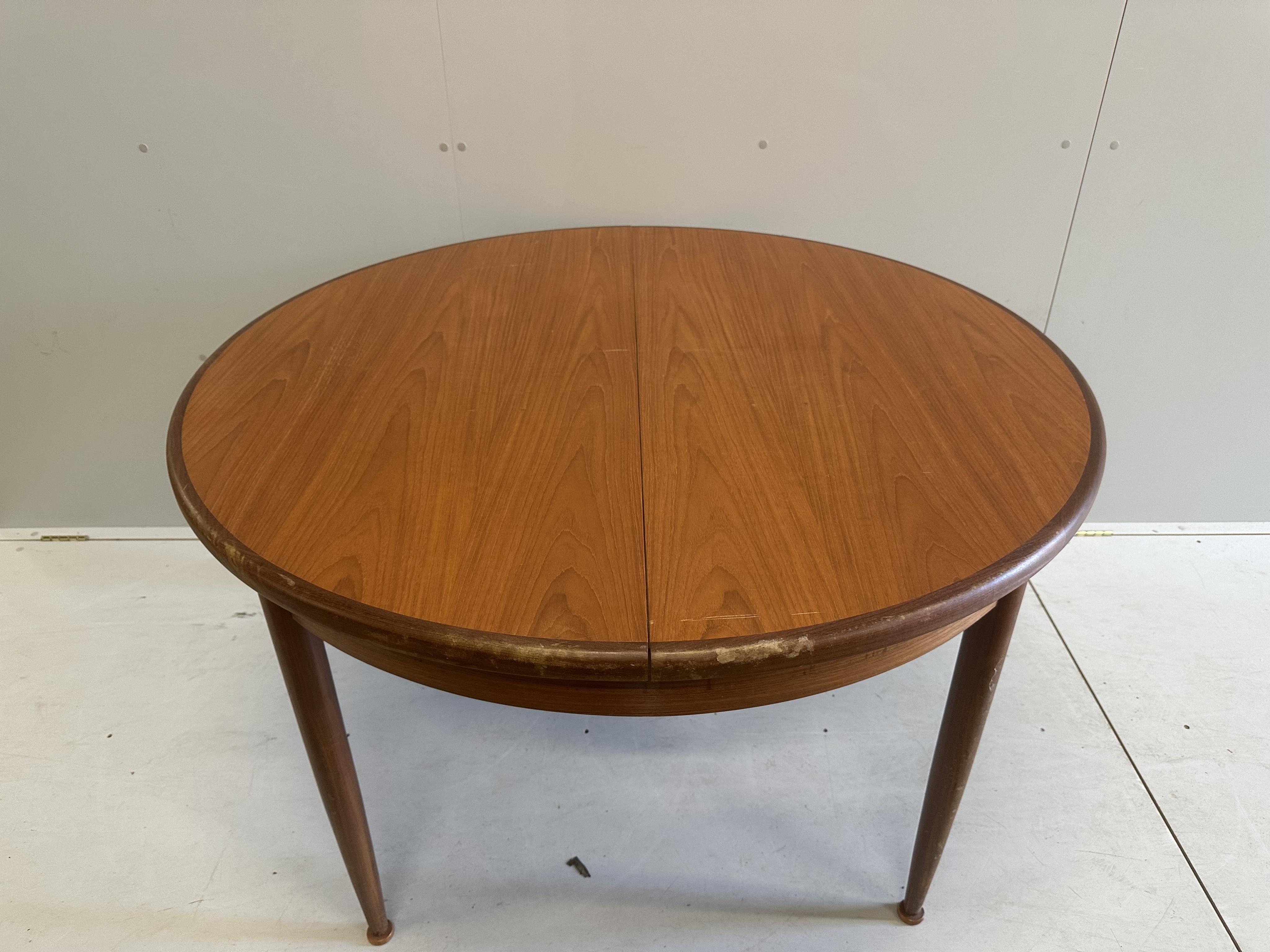 A G Plan circular teak extending dining table, diameter 120cm, height 74cm, and six chairs. Condition - fair